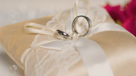 Close-Up-Of-Wedding-Rings-For-Bride-And-Groom-On-Small-Decorated-Cushion-2